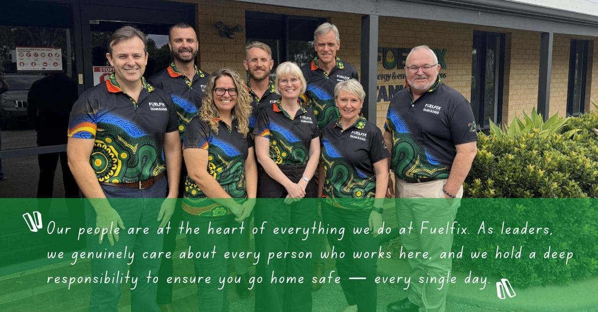 A group of Fuelfix team members standing together outside a company facility, wearing coordinated uniforms, representing the organisation’s commitment to strong leadership, teamwork, and a culture centred on employee safety and wellbeing.